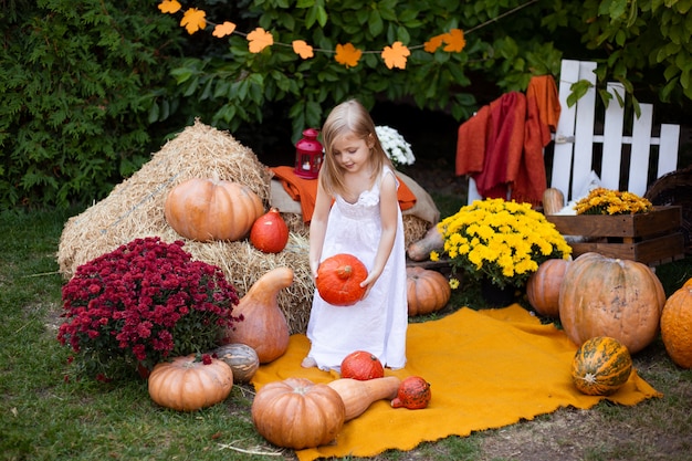 Little cheerful girl with pumpkin