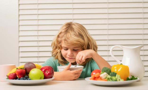 Photo little child boy having healthy breakfast kids nutrition and development eating vegetables by child make them healthier