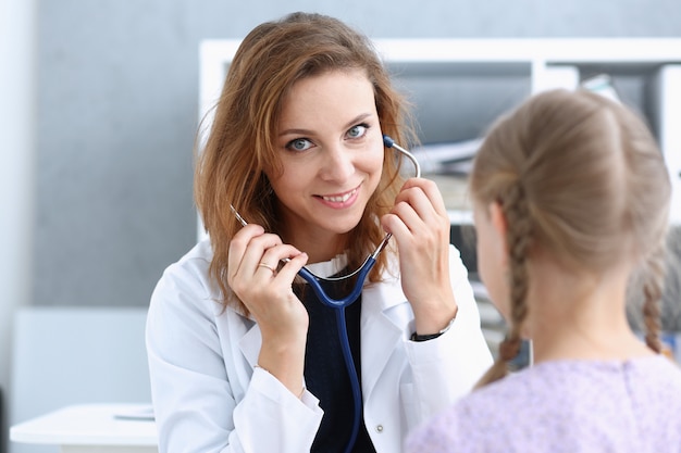 Little child at pediatrician reception. Physical exam appointment, cute infant portrait, baby aid, ward round, child sickness, clinic test, high quality and trust concept