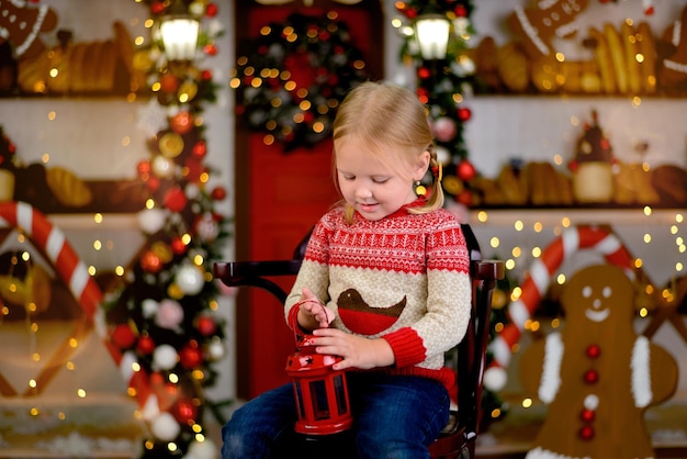 Little child playing with christmas toys. Happy new year! Christmas decoration interior.