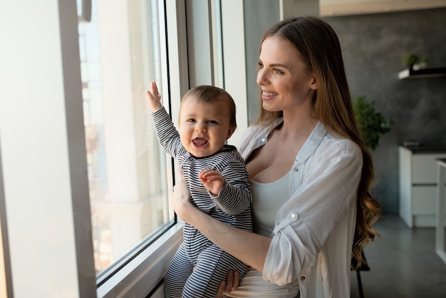 Little child smiling and happy with mom on the sofa