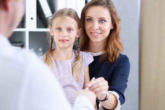 Little child with mother at pediatrician reception.