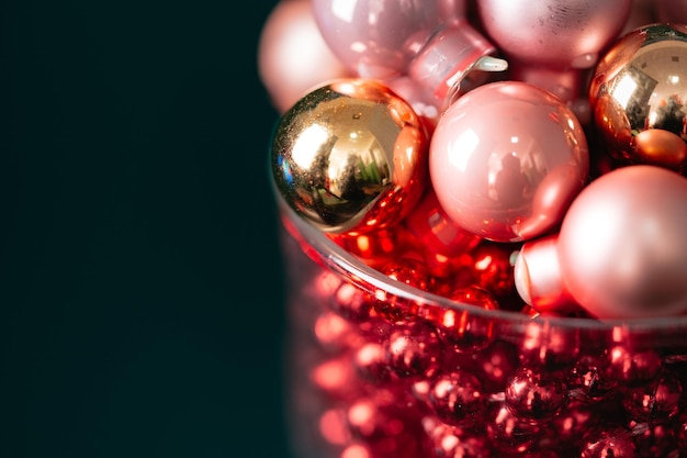 Little christmas baubles in wineglasses on a dark background