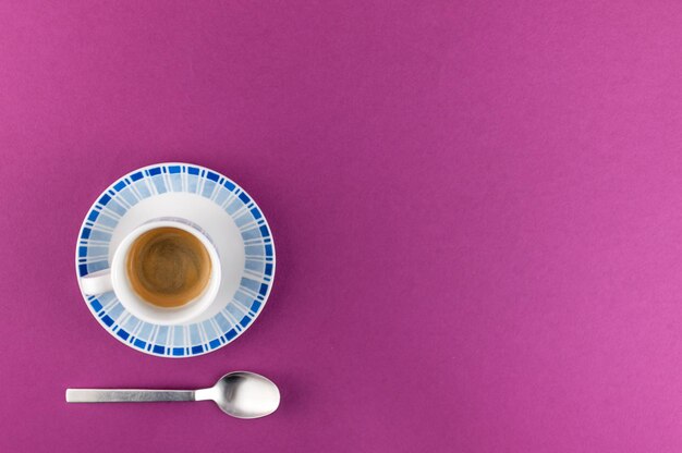 Little cup of coffee on colored background