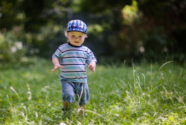 little cute baby is walking on the grass