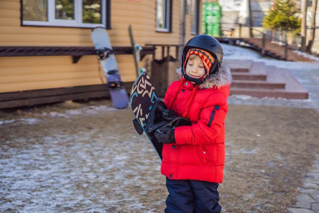 Little cute boy is ready for snowboarding Activities for children in winter Children's winter sport Lifestyle