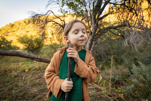 Little cute girl 5 years old enjoys nature on a weekend hike