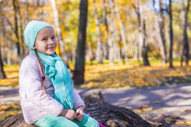 Little cute girl in autumn park