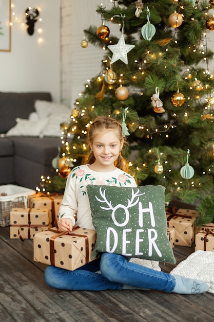 Little cute girl near christmas tree