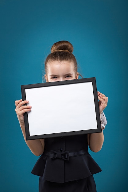 Little dark hair child with papers dressed like teacher in black dress