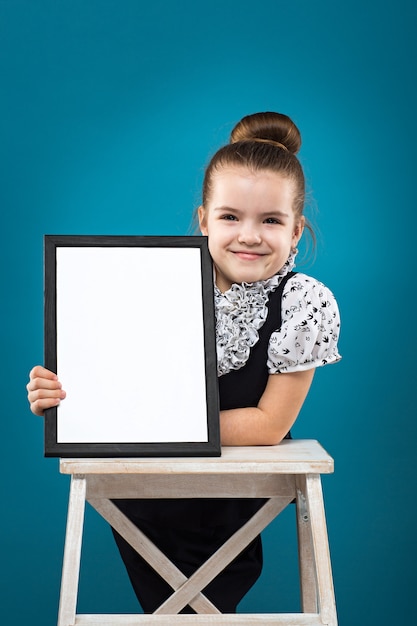 Little dark hair child with papers dressed like teacher in black dress