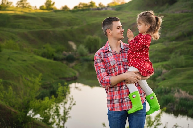 Little daughter in her father's arms Fatherhood concept