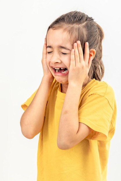 Little desperate girl looking panic holding her head with both hands