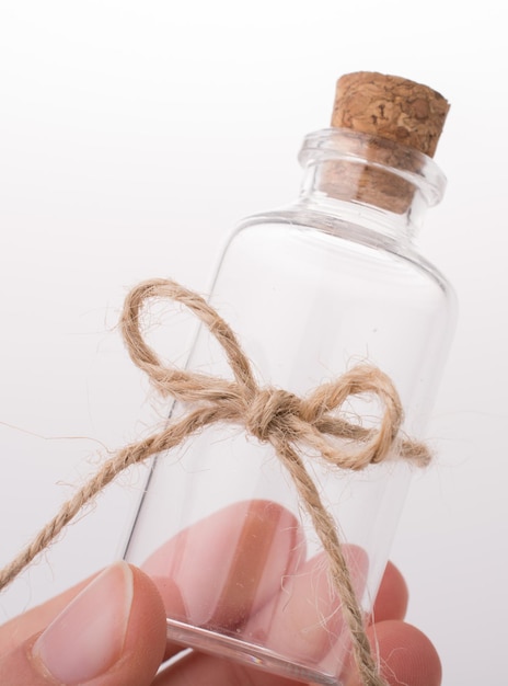 Little empty glass bottle in hand