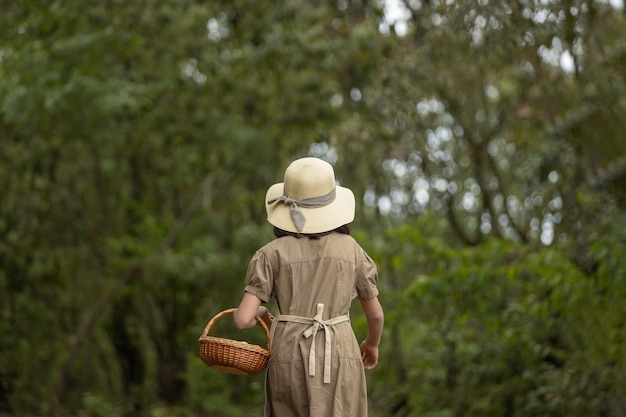 Little farmer girl walking on the field