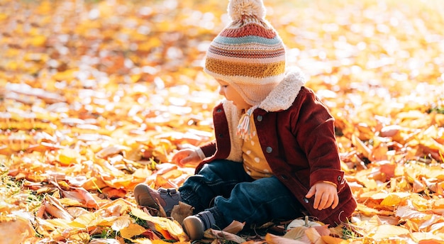 Little fashionable and stylish child autumn park