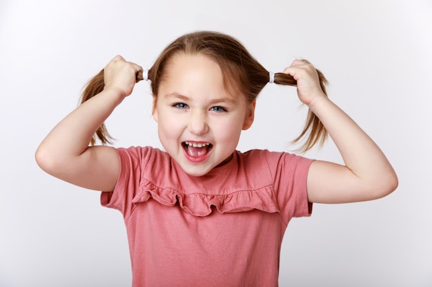 Little funny girl pulling her hair out