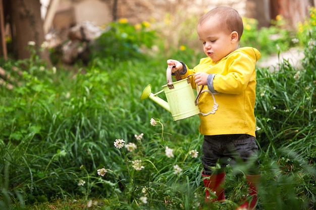 Little gardener watering the garden