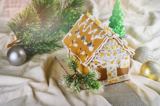 Little gingerbread house with glaze standing on table 