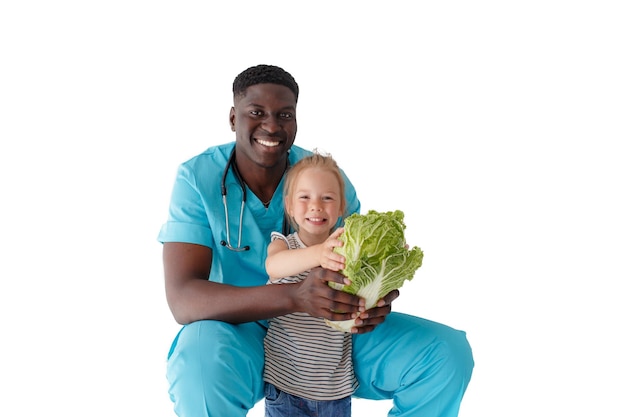 A little girl on the advice of a doctor chooses greens for a proper and healthy diet