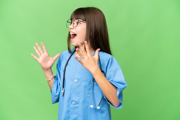 Little girl as a surgeon doctor over isolated chroma key background with surprise facial expression