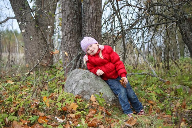 Little girl in autumn forest