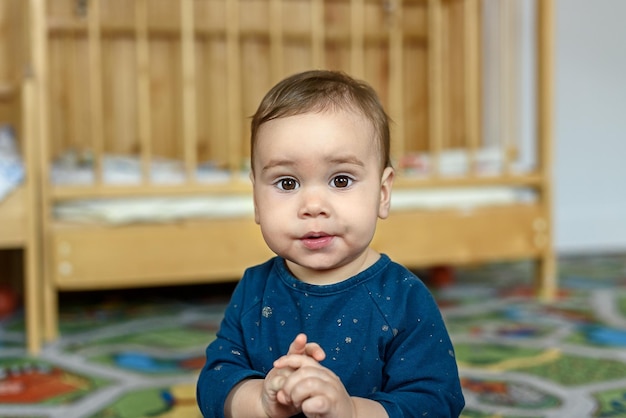 Little girl baby one year old in the nursery