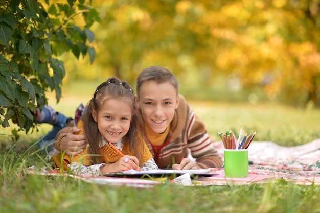 Little girl and boy drawing with pencils