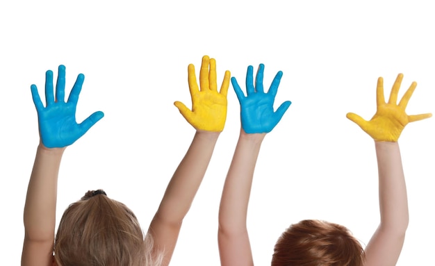 Little girl and boy with hands painted in Ukrainian flag colors on white background closeup Love Ukraine concept