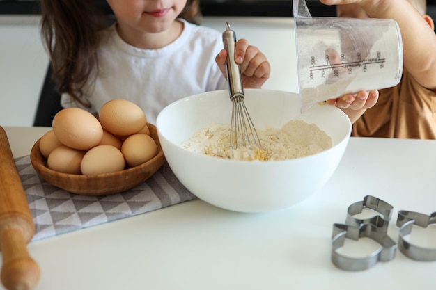 Little girl breaking an egg closeup cooking master class