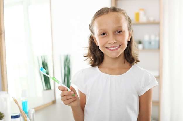 Little girl brushes her teeth dental care for children