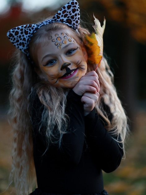 Little girl celebrates Halloween in the park