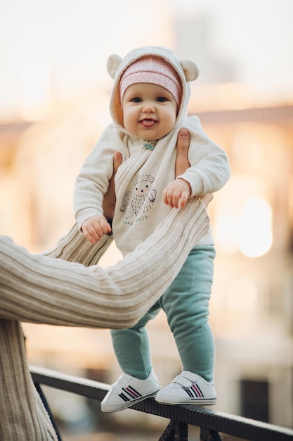 A little girl child in the autumn park smiles spends time Beautiful autumn background