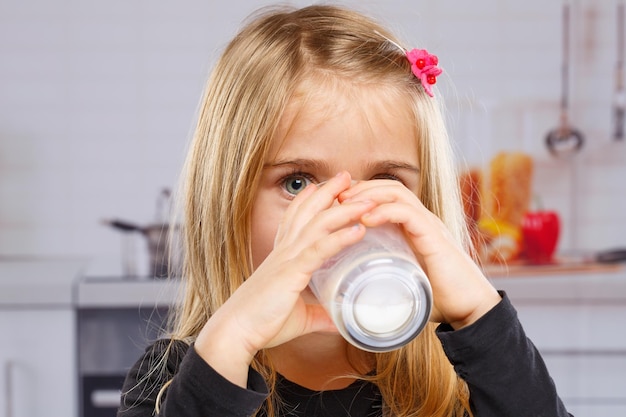 Little girl child drinking milk kid glass healthy eating