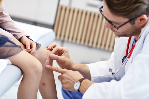 little girl in clinic being examined by dermatologist