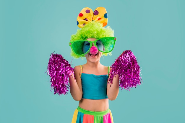 Little girl in clown costume with pom poms