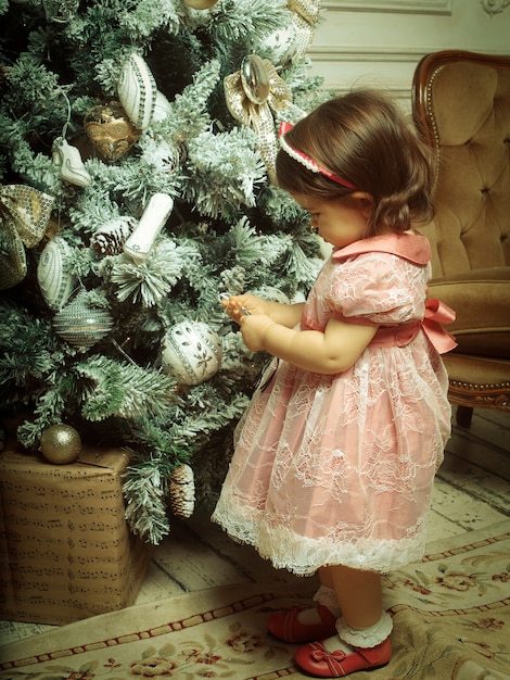 Little girl decorating Christmas tree