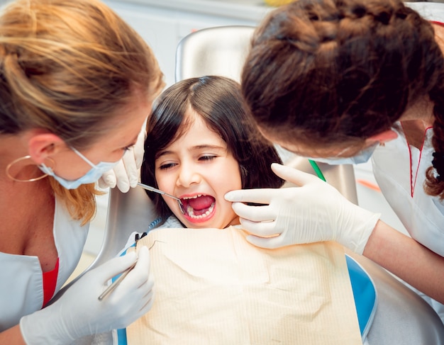 Little girl at the dental office. Calm and happy.