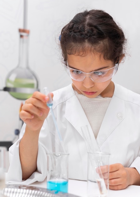 Little girl doing a science experiment at school