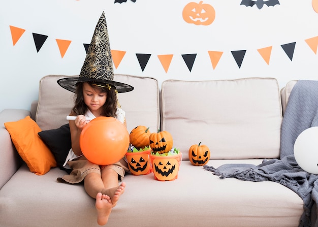 Little girl drawing a halloween baloon