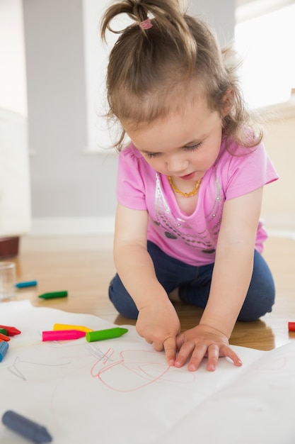 Little girl drawing in living room