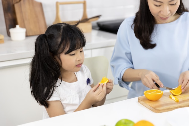  Little girl eating oranges