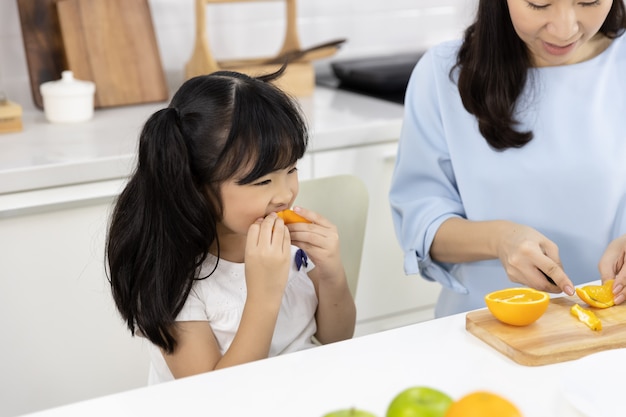  Little girl eating oranges