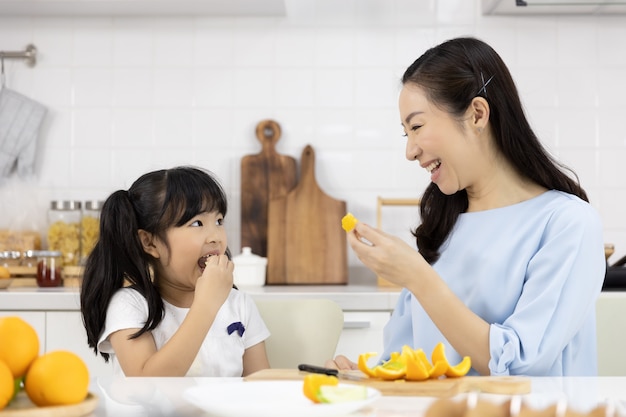  Little girl eating oranges