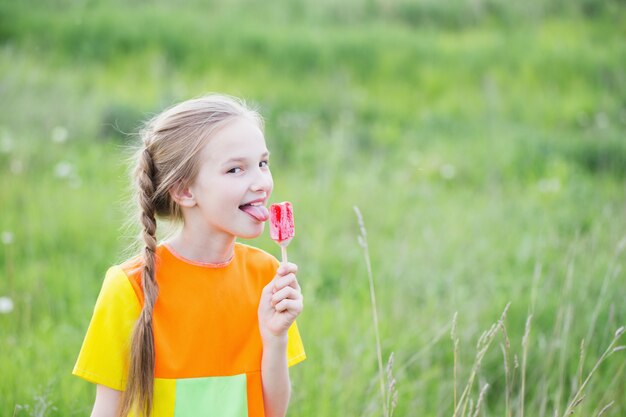 Little girl eats ice-cream in the summer