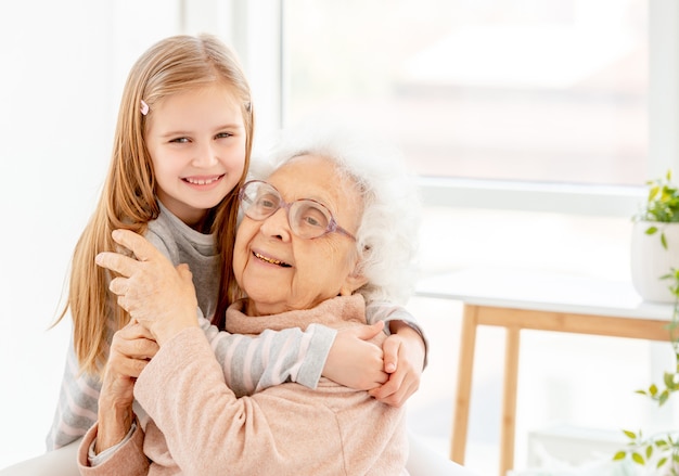 Little girl embracing her grandmother