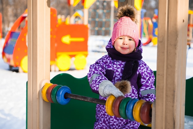 Little girl enjoying beautiful winter day outdoors