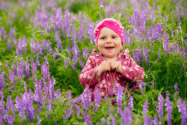 A little girl in a field with purple flowers