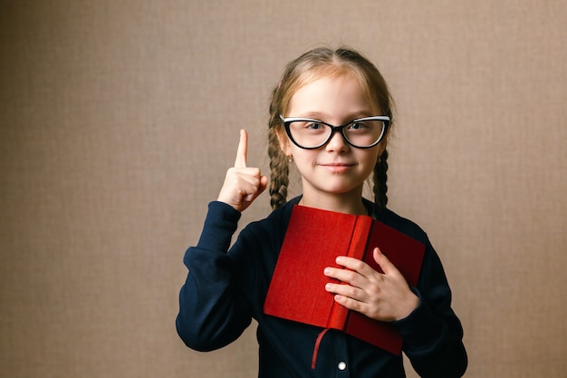 Little girl in glasses with book