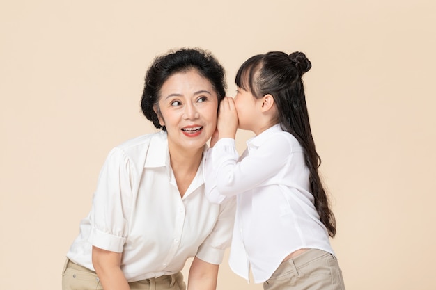 Little girl and grandma whispering